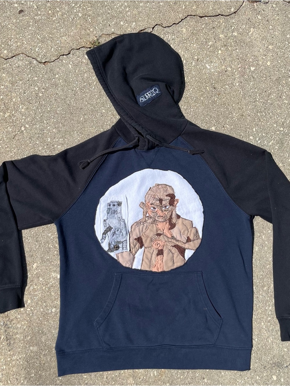 Graphic Navy & Black Pullover Hoodie with Character Patch by designer AIRRIQ